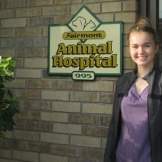 Christine Emeny next to Fairmont Animal Hospital logo